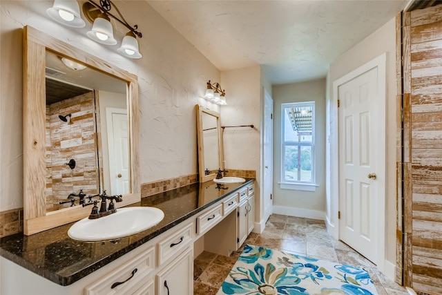 bathroom featuring walk in shower and vanity