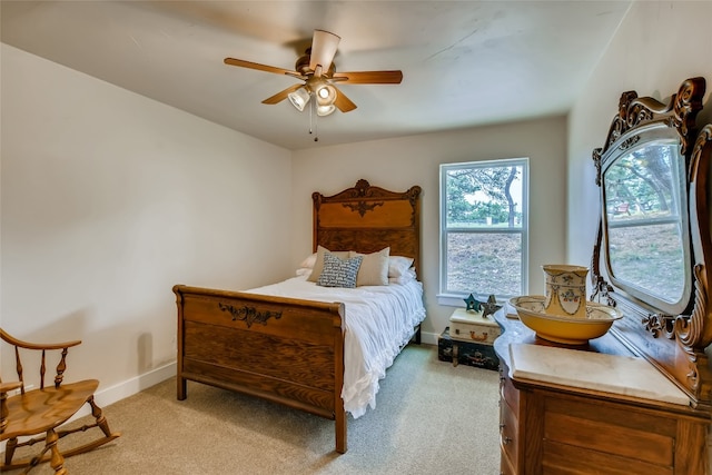 bedroom with ceiling fan and light colored carpet