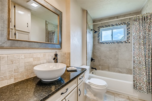 full bathroom featuring vanity, shower / bathtub combination with curtain, tile patterned floors, tile walls, and toilet