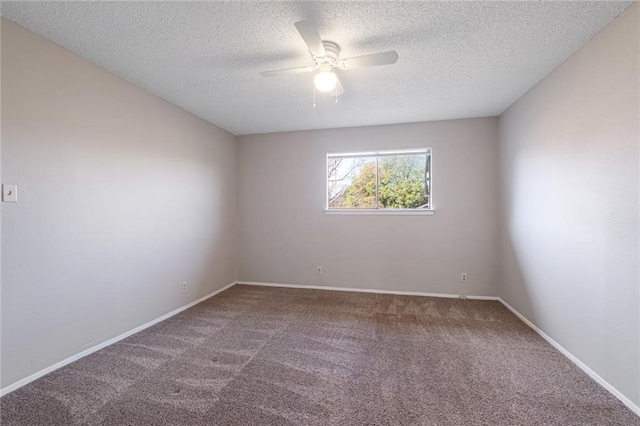 carpeted spare room featuring ceiling fan and a textured ceiling