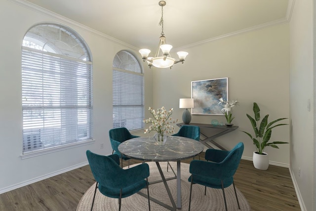 dining room with ornamental molding, an inviting chandelier, and dark wood-type flooring