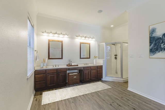 bathroom featuring ornamental molding, vanity, hardwood / wood-style flooring, and an enclosed shower