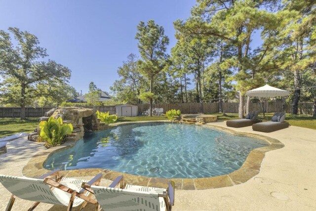 view of pool featuring a patio area and a shed