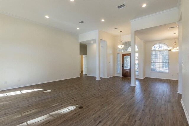 foyer featuring ornamental molding, a notable chandelier, and dark hardwood / wood-style flooring