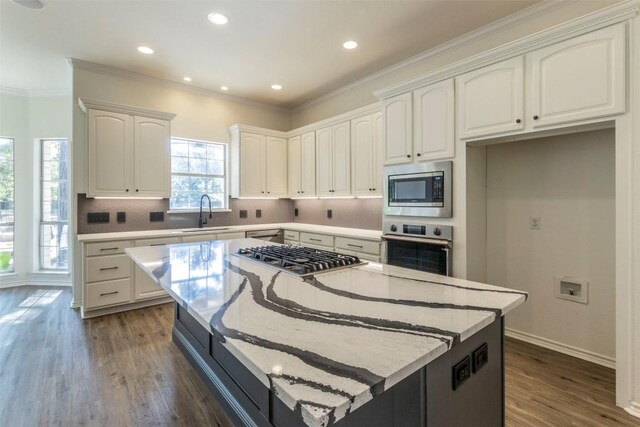 kitchen featuring stainless steel appliances, a center island, dark hardwood / wood-style flooring, and white cabinetry