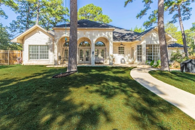 back of house featuring fence, french doors, a yard, a patio area, and a ceiling fan