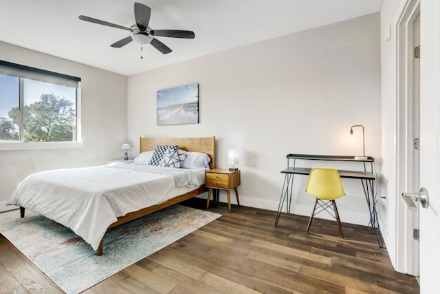 bedroom with dark hardwood / wood-style floors and ceiling fan