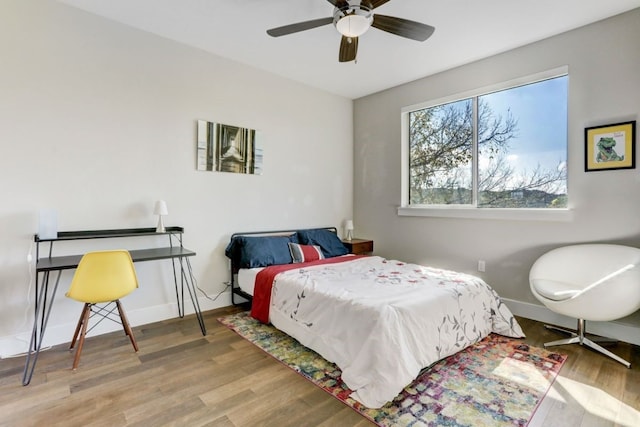 bedroom with light hardwood / wood-style flooring and ceiling fan