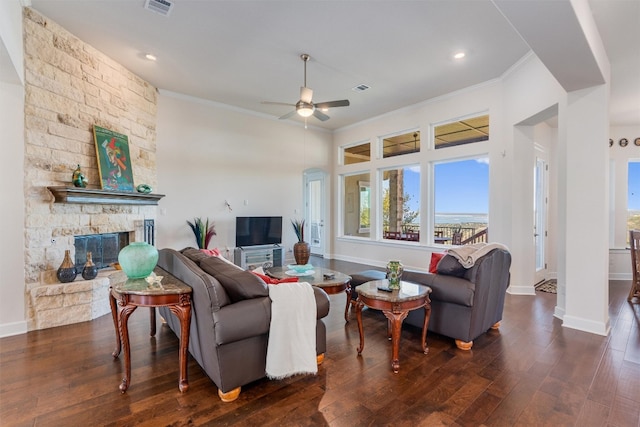 living room with ceiling fan, a fireplace, dark wood-type flooring, and ornamental molding