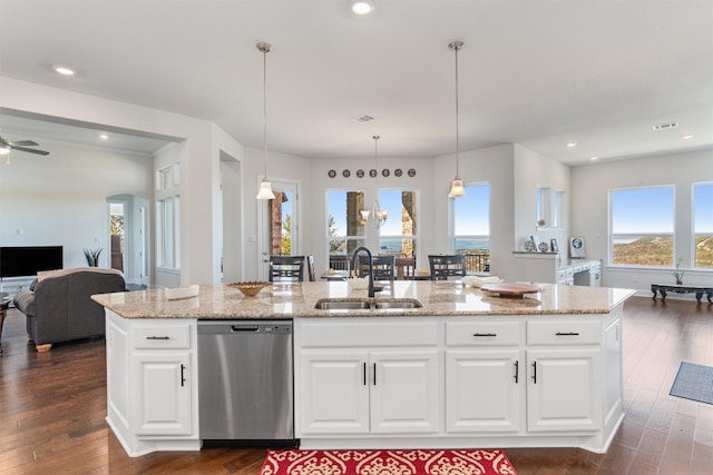 kitchen featuring stainless steel dishwasher, white cabinetry, sink, and a kitchen island with sink