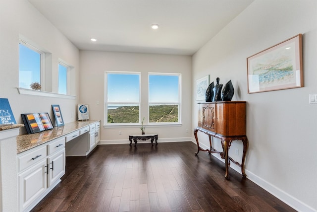 sitting room featuring built in desk and dark hardwood / wood-style floors