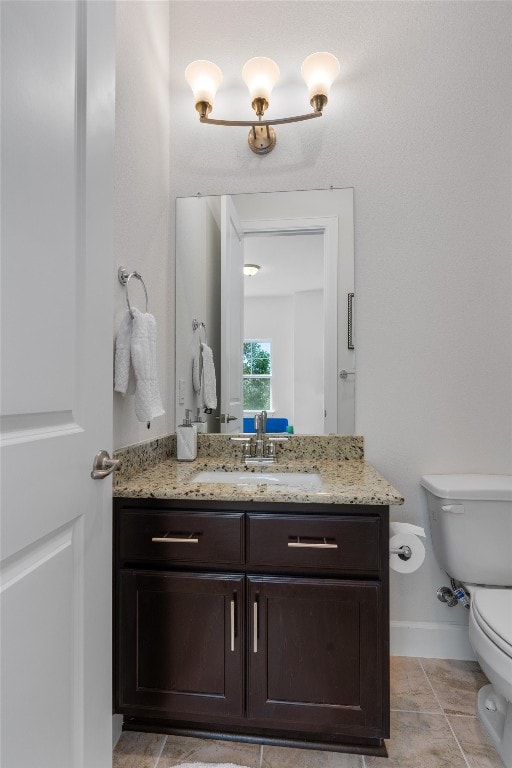 bathroom with tile patterned floors, vanity, and toilet