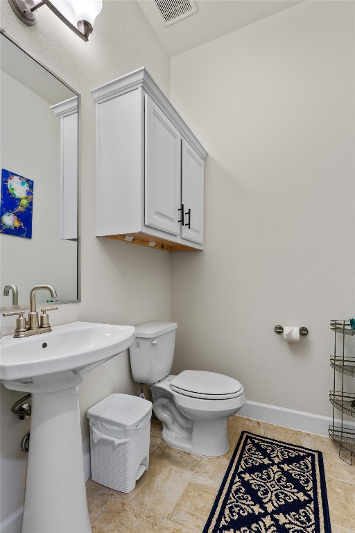 bathroom featuring sink, tile patterned flooring, and toilet