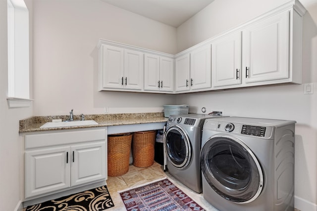 laundry area with washer and dryer, cabinets, light tile patterned floors, and sink