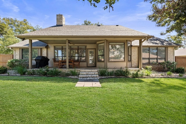 back of house featuring a lawn