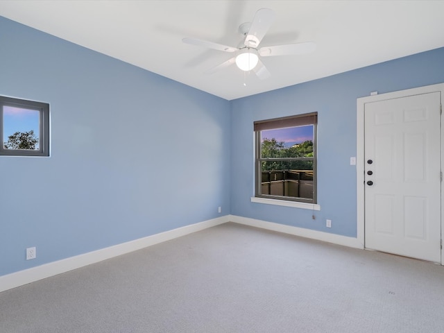 spare room featuring ceiling fan and carpet flooring