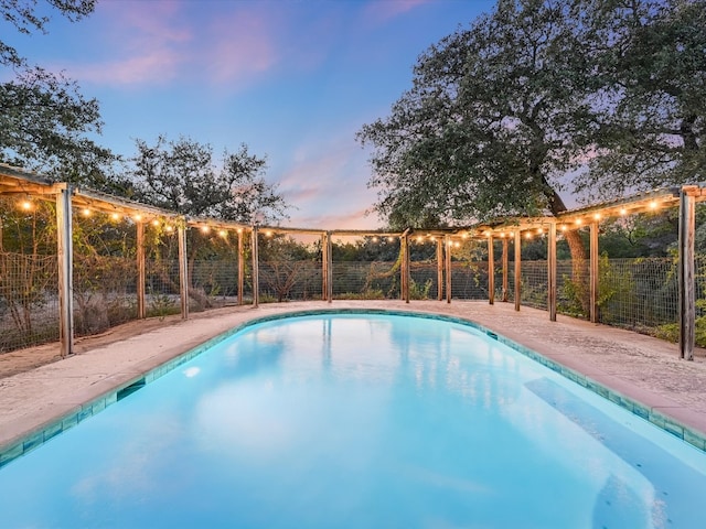 view of pool at dusk