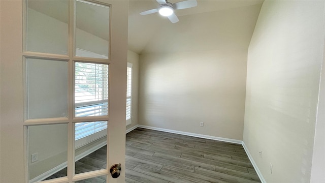 spare room with hardwood / wood-style floors, ceiling fan, and lofted ceiling