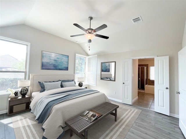 bedroom with ceiling fan, light hardwood / wood-style flooring, and lofted ceiling