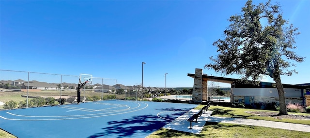 view of sport court featuring a yard