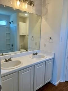 full bathroom featuring hardwood / wood-style floors,  shower combination, vanity, and toilet