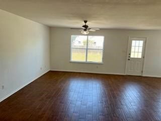 unfurnished room featuring ceiling fan and dark hardwood / wood-style flooring