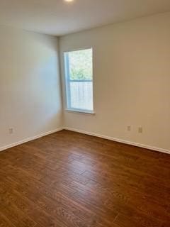 spare room featuring dark hardwood / wood-style flooring