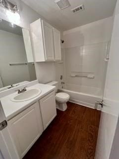 full bathroom featuring wood-type flooring, vanity, toilet, and  shower combination