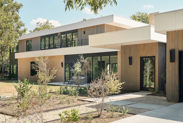 view of front facade with a patio area and a balcony