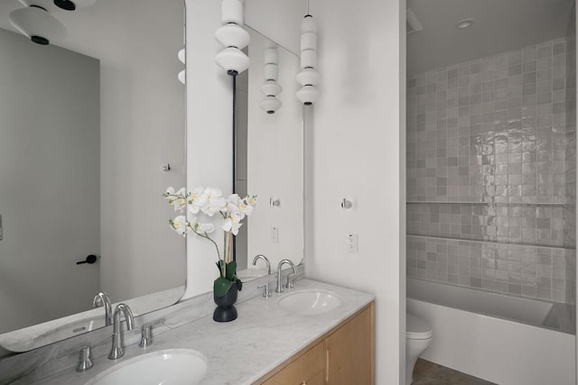 full bathroom with vanity, toilet, and tiled shower / bath