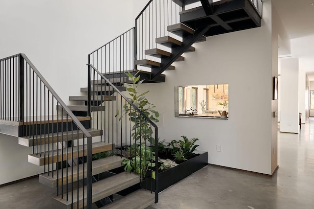 staircase with concrete floors