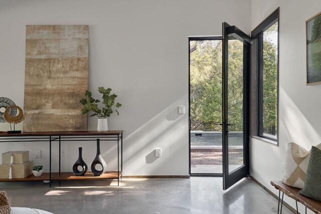 doorway to outside with concrete floors