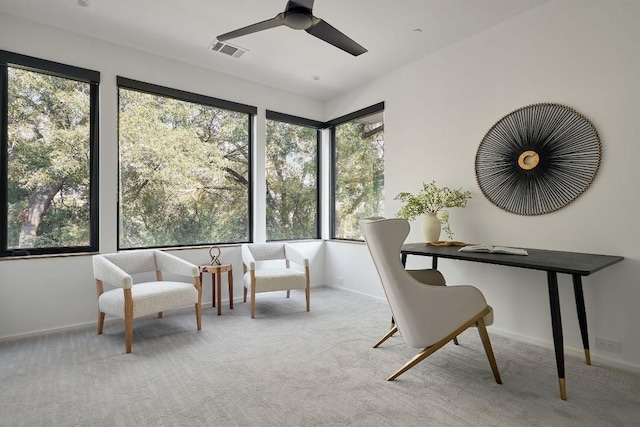 interior space with ceiling fan and light colored carpet