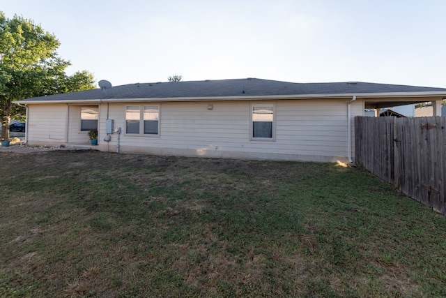 rear view of house with a yard