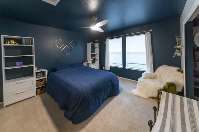 bedroom with light carpet and ceiling fan