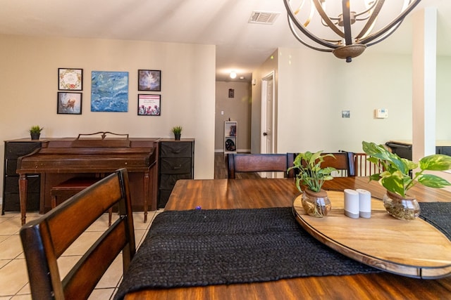 dining room with a notable chandelier and light tile patterned floors