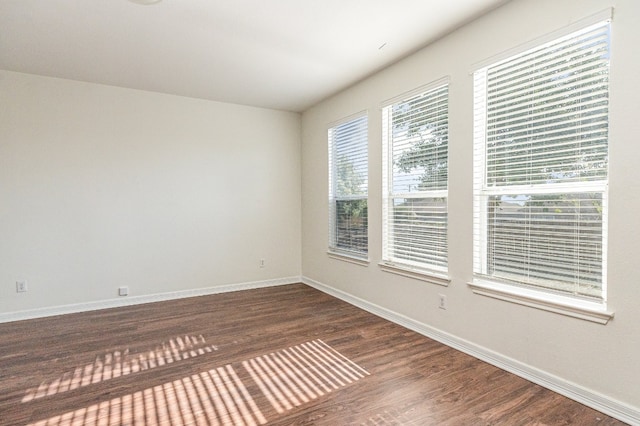 spare room with dark hardwood / wood-style flooring