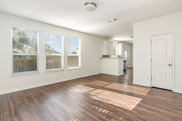 unfurnished living room with dark wood-type flooring