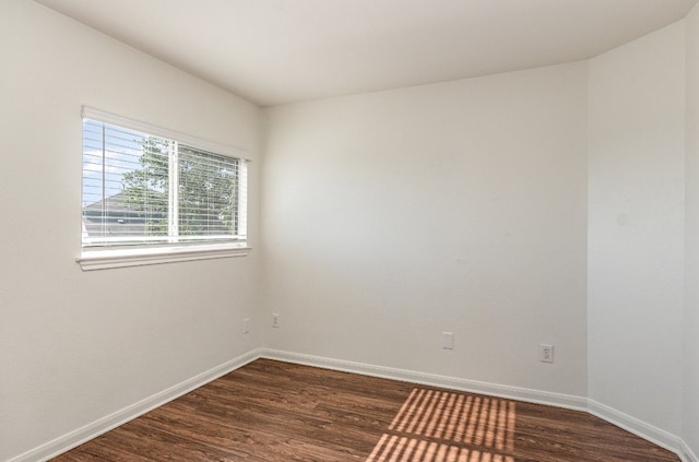 empty room with dark wood-type flooring