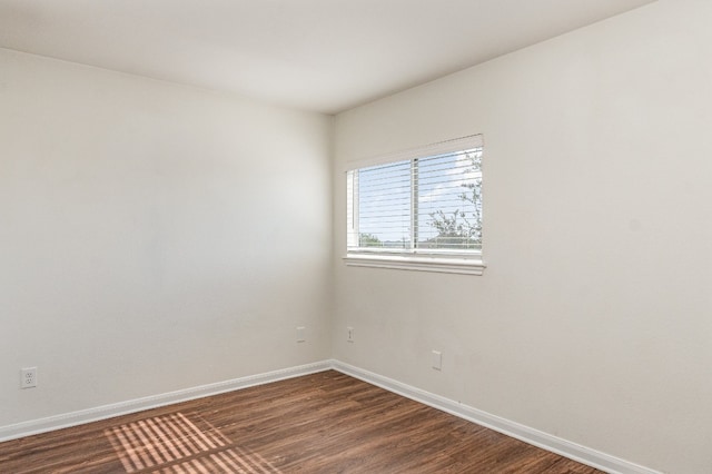 empty room featuring dark wood-type flooring