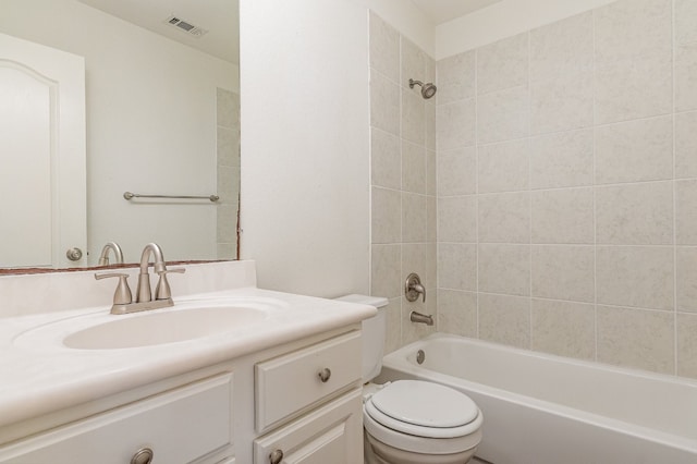 full bathroom featuring toilet, tiled shower / bath combo, and vanity