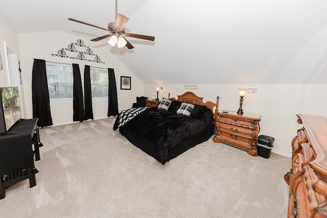 bedroom with ceiling fan, lofted ceiling, and light carpet