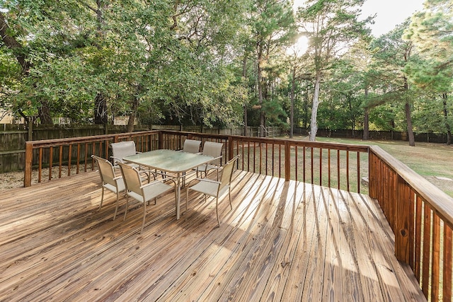 wooden terrace featuring a lawn