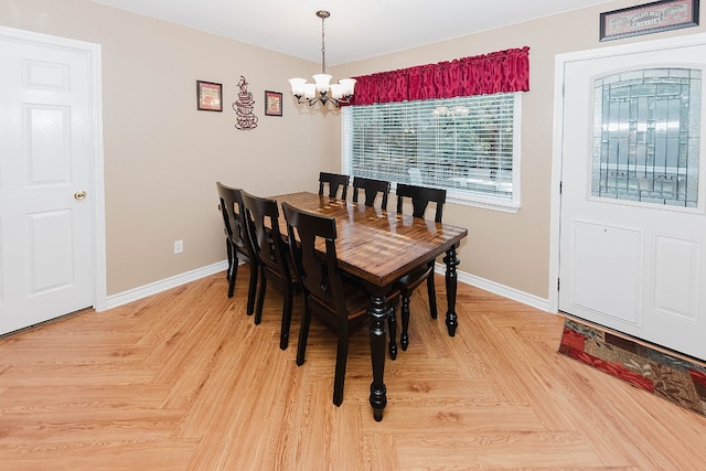 dining room with a notable chandelier and light parquet flooring