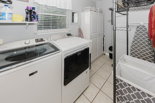 washroom featuring separate washer and dryer and light tile patterned flooring