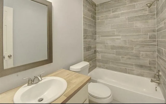 full bathroom with vanity, tiled shower / bath combo, and toilet