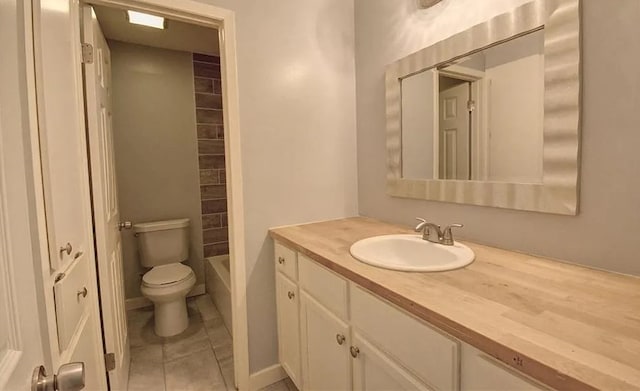 full bathroom with tile patterned floors, washtub / shower combination, vanity, and toilet