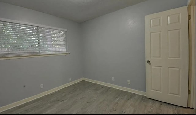 unfurnished room with light wood-type flooring