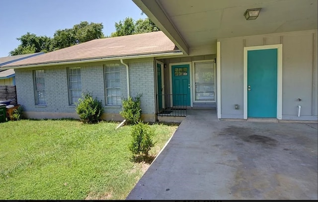 view of exterior entry featuring a yard