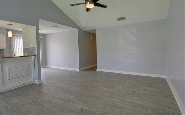 spare room featuring vaulted ceiling, ceiling fan, and hardwood / wood-style flooring